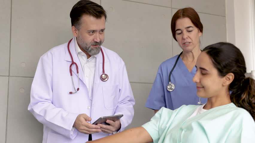 Physiotherapy rehabilitation therapist caregiver nurse working with specialist for Hispanic patient woman pain office syndrome exercise female injury lay down admit in modern physical therapy hospital