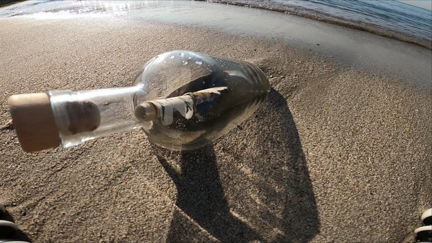 Message in a bottle on the summer island beach