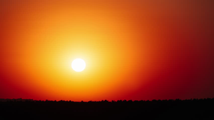 Timelapse awesome sunset moving down in the clear orange sky. A bright setting sun with a halo in the atmosphere is setting down above the horizon. Epic, vibrant color. Time Lapse. Beautiful sundown Royalty-Free Stock Footage #1109833607