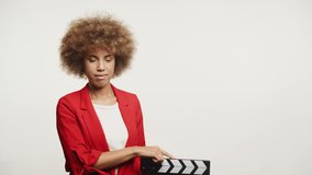 Woman Holding Clapperboard on White Background
