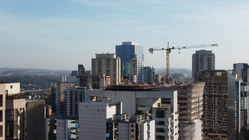 Aerial Shot Orbiting a Building Under Construction With a Crane | Shutterstock HD Video #1109835733