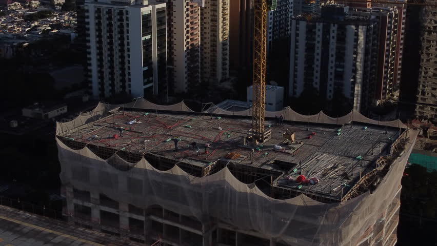 Orbiting a Construction Crane Of a Residencial Building With Man At Work | Shutterstock HD Video #1109835739