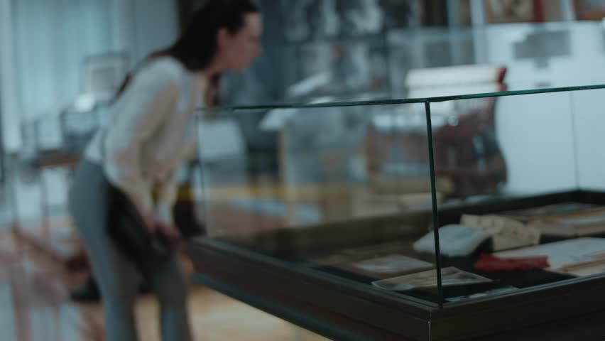Young woman looking at a vintage accordion in museum. No focus. 2023, Museum of History, Chisinau, Moldova