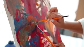 Close up paintbrush acrylic and oil paint on canvas. Lesson at Art School for Adults Children in Art Class with painting. - Powered by Shutterstock - Get 15% off with code: PIKWIZARD15