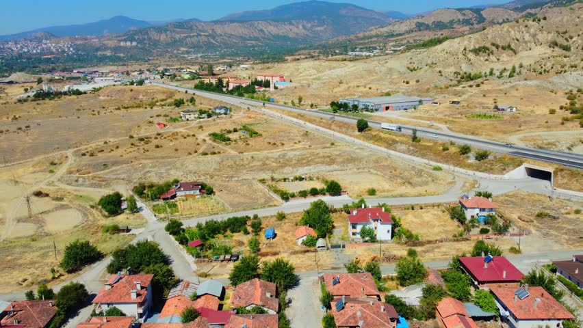Drone view of Turkish landscape and highway with car traffic along mountains. Scorched earth and yellow grass. Drought and Sun Valley in Southern Countries. Federal highways along mountain range.