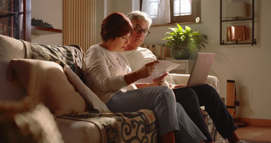 At home, a middle-aged couple monitors bills and taxes to pay and must be careful about their household finances.
The two pensioners are sad and worried Royalty-Free Stock Footage #1109845015