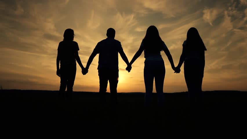 Silhouette of group of people. People holding hand together symbol of unity and helping hand in business. Teamwork unity freedom people. Team of people holding hands together support success victory