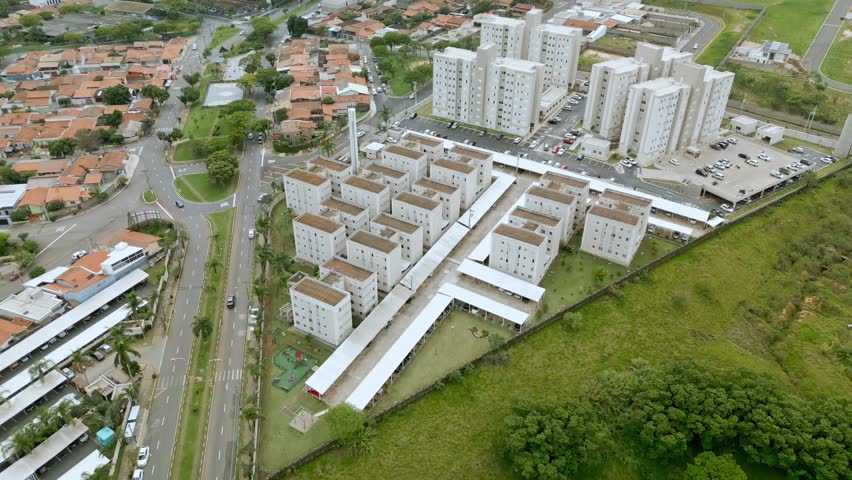 Aerial view of the city of Paulínia with its buildings, next to green trees and urban traffic. Sao Paulo, Brazil. 