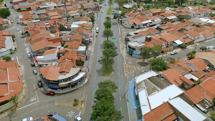 Aerial view of the city of Paulínia with its buildings, orange-roofed houses on a cloudy day. Sao Paulo, Brazil. 