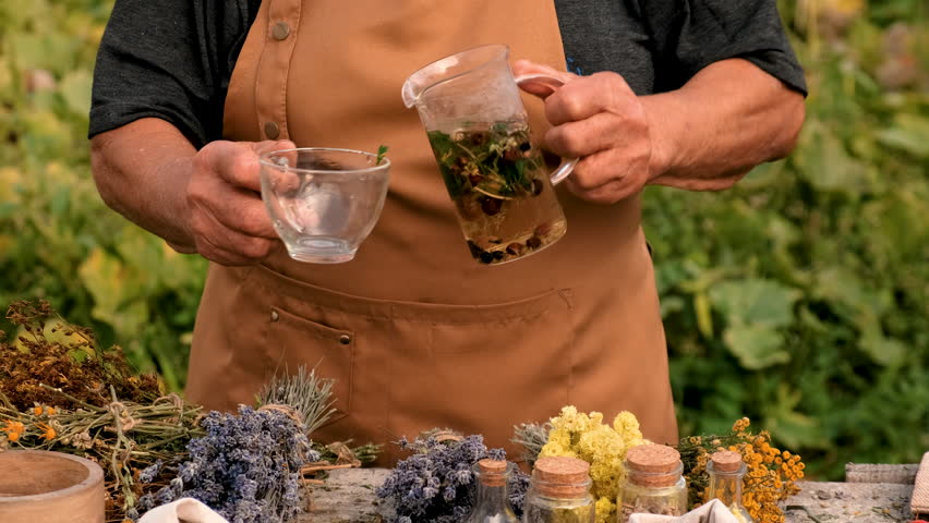 Woman and herbs and dried flowers alternative medicine and medicinal tea. Selective focus.