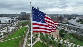 American flag waving high above Omaha riverfront parks and skyline. Aerial establishing shot. - Powered by Shutterstock - Get 15% off with code: PIKWIZARD15