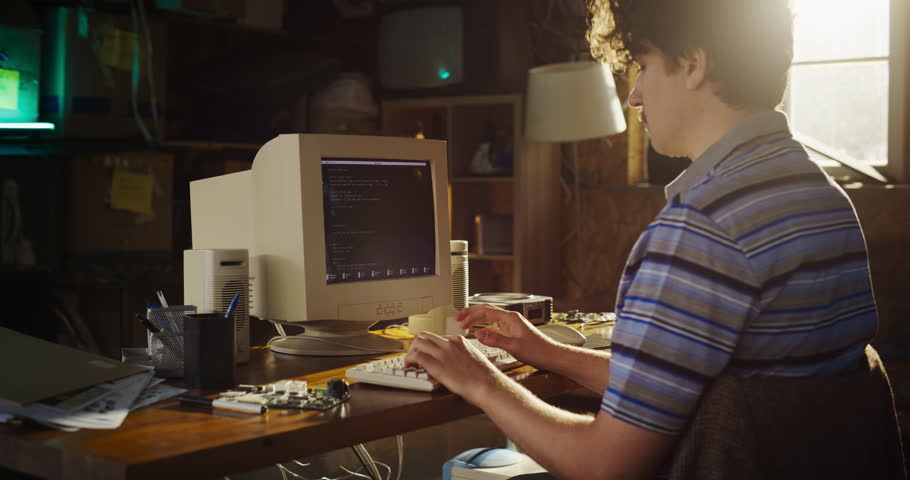 Zoom In Shot Of Caucasian Male Hardware Engineer Programming On Old Desktop Computer In Retro Garage. Experienced Software Developer Writing Code For New Innovative Operating System In Nineties.