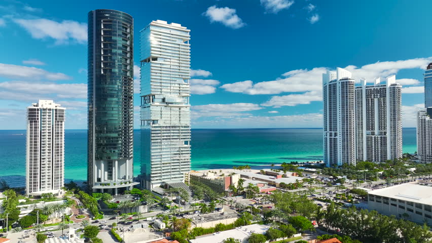 Expensive high-rise hotels and condos on Atlantic ocean shore in Sunny Isles Beach city. American tourism infrastructure in southern Florida Royalty-Free Stock Footage #1109862059