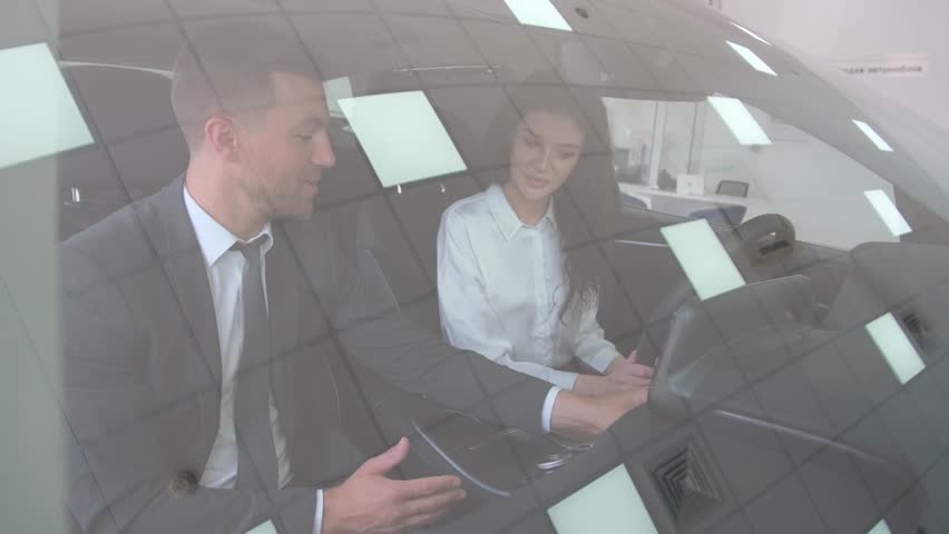 A brunette woman is sitting in the driver