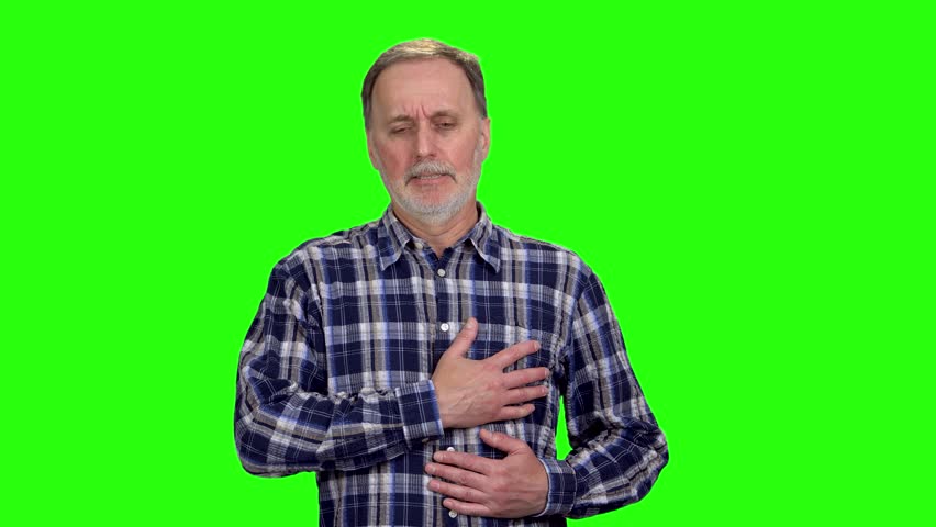 Mature caucasian man having a heart attack and touching his chest. Isolated on green. Royalty-Free Stock Footage #1109867447