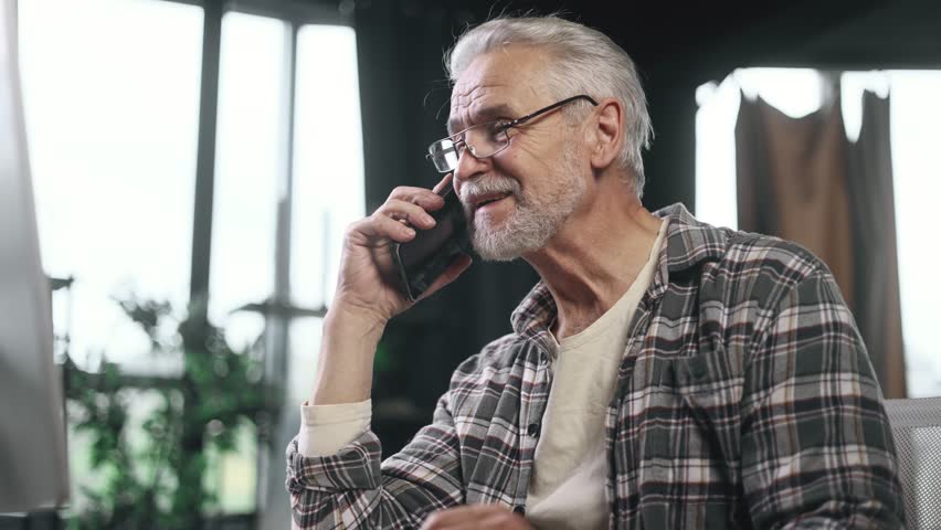 Portrait of busy gray haired senior businessman talking by smartphone cellphone with client in modern workplace Confident mature office worker at the desk and working on the computer indoors - Powered by Shutterstock - Get 15% off with code: PIKWIZARD15