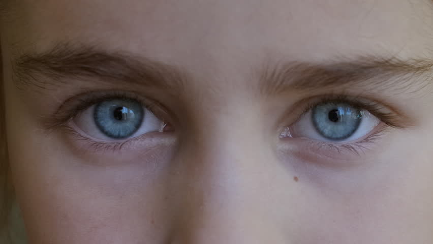 Blue Eye of Child Looking at Camera Close Up. Macro Shot Opening and Closing Blue Eyes Little Girl. Close Up Motion of Children Eyes. Human Eye Iris Opening Pupil. Royalty-Free Stock Footage #1109876629