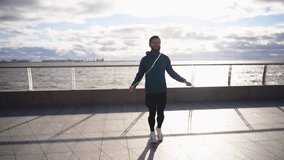 Man warm-up cardio workout uses a jump rope jumps on the spot intense workout. Motivation a person who trains fitness, an active lifestyle. Slow motion video. - Powered by Shutterstock - Get 15% off with code: PIKWIZARD15