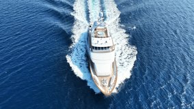 Aerial drone tracking video of latest technology yacht cruising near famous beach of Super paradise, Mykonos island, Cyclades, Aegean sea, Greece