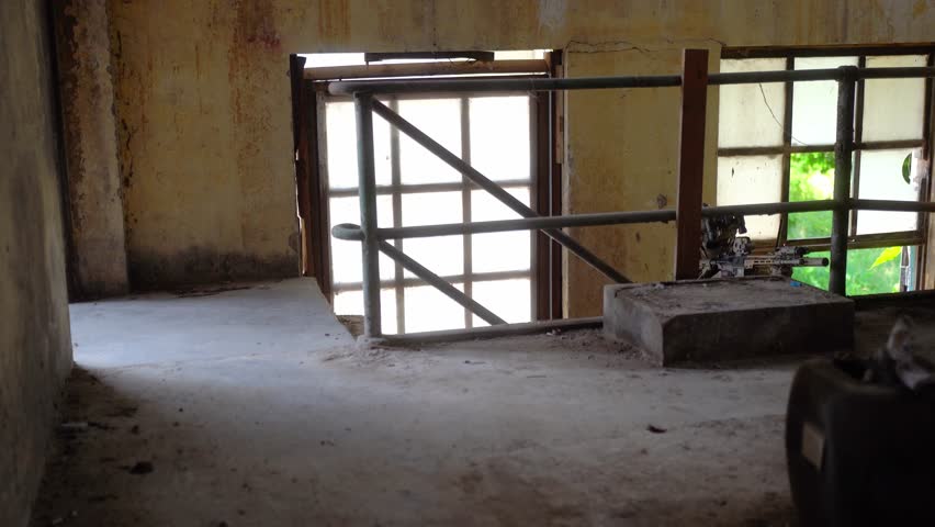 Soldier in full US MARSOC armed with assault rifle run through the abandoned building. Military clash.