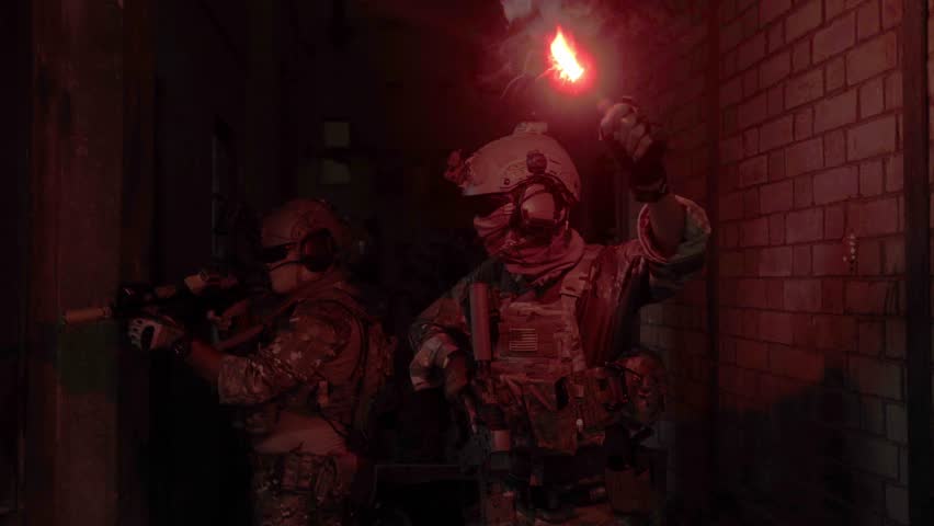 Soldier in full US MARSOC armed with assault rifle run through the abandoned building. Military clash.