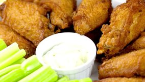 Tempting 4K Video: Chicken Wings with Savory Sauce and Crisp Celery