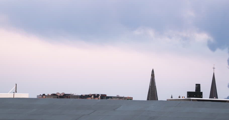 Pan over roofs as smoke rolls over roofs in Antwerp, Belgium.
