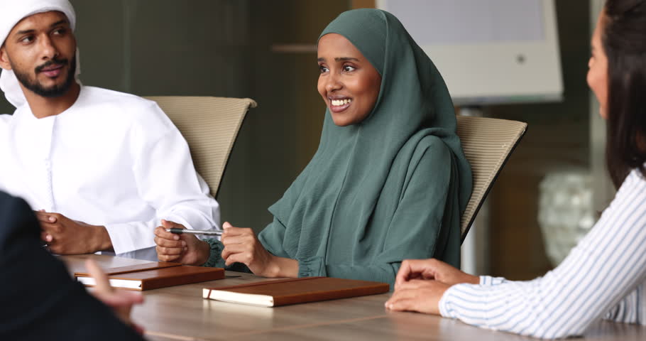Beautiful Sudanese businesslady in hijab lead meeting with businesspeople in office, female boss in traditional muslim wear make speech, hold briefing, share strategy with partners in conference room Royalty-Free Stock Footage #1109893389