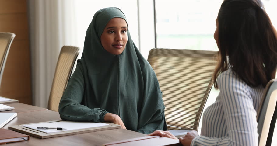 Somalian businesswoman in hijab shake hands colleague after meeting in office boardroom, achieving agreement, sell or buy company services, finish negotiations feel satisfied with deal and cooperation Royalty-Free Stock Footage #1109893489