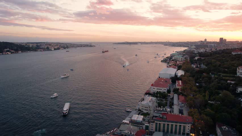 Drone video of Bosphorus in Istanbul during sunset. First and second bridge filmed from above. Turkiye flag waving. Ships passing under the bridge. | Shutterstock HD Video #1109896887