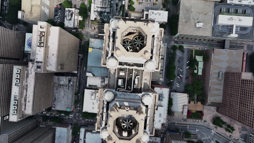 Top down rotating footage of high rise downtown buildings in modern city. Large rooftop ventilation fans. Atlanta, Georgia, USA