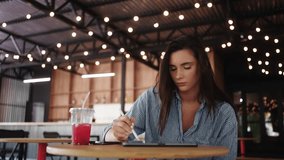 Young Student Woman Working Online Or Resting In Cafe, Portrait Of Woman With Tablet And Stylus - Powered by Shutterstock - Get 15% off with code: PIKWIZARD15