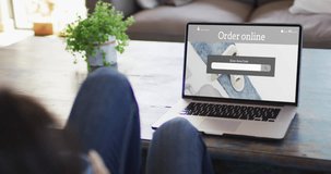 Knees of woman at table using laptop, online shopping for clothes, slow motion. Retail business, sale and digital interface digitally generated video.