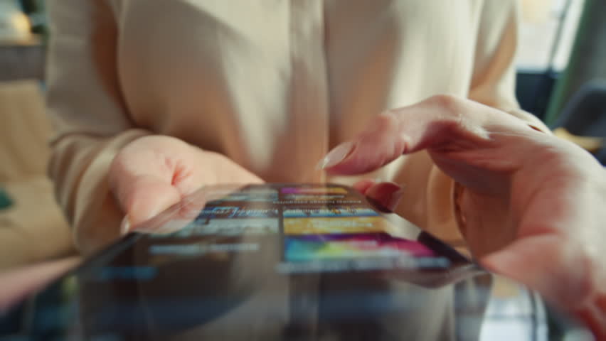 Close-up shot of young woman holding smartphone, scrolling online games on game platform. Footage of girl using app store for leisure and entertainment. Purchase concept Royalty-Free Stock Footage #1109906215