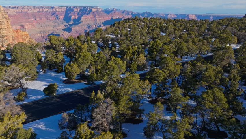 Driving In The Road Passing Through Snow Forest Near Grand Canyon National Park In Arizona, United States. Aerial Shot