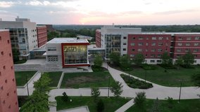 Modern college dormitories in university campus in USA. Aerial establishing shot of student housing at dusk during sunset. - Powered by Shutterstock - Get 15% off with code: PIKWIZARD15