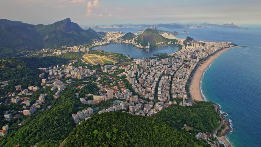 Drone Footage of the Mountains Dois Irmaos located in Rio De Janeiro in Brazil. This is a stationary footage above Dosi Irmaos to show the disctricts or LeBlond and Ipanema and the corcovado.