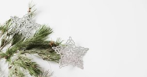 Video of fir tree branches christmas decorations with copy space on white background. Christmas, decorations, tradition and celebration concept.