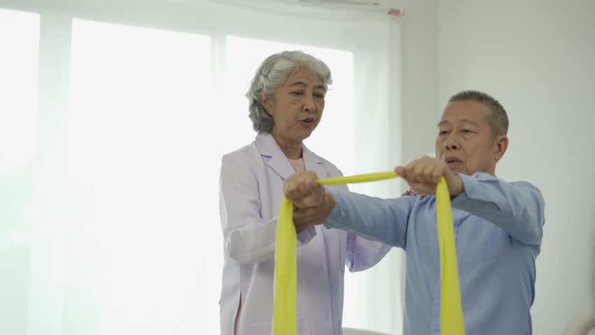 Senior man with physical therapist senior woman exercising Do physical activities and recover from injuries with the help of a physical therapist. Royalty-Free Stock Footage #1109913673