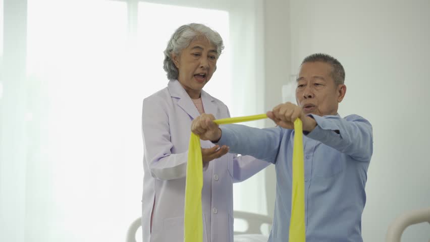 Senior man with physical therapist senior woman exercising Do physical activities and recover from injuries with the help of a physical therapist. Royalty-Free Stock Footage #1109913675