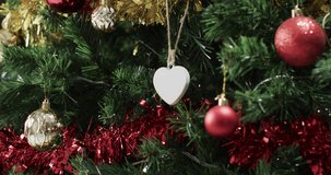 Video of christmas tree with decorations and heart with copy space. Christmas, decorations, tradition and celebration concept.