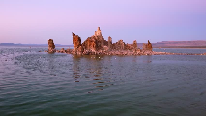 Mono Lake stalagmites of the tufa. Scenic magenta sunset. Spectacular sedimentary formations along the shores of Mono Lake. The Mono Lake Tufa State Natural Reserve in California, United States.