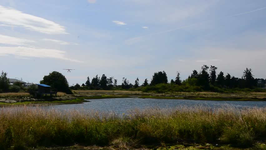 Float plane landing at lake in Canada/ float plane