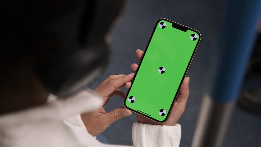 Woman using smartphone with vertical green screen display watching movie, video content on train. Browsing social network, news. Girl using smartphone internet surfing communication online. Close up Royalty-Free Stock Footage #1109916929