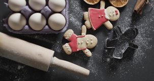 Vertical video of christmas cookies with sugar and copy space on black background. Christmas, dessert, baking, decorations, tradition and celebration concept.