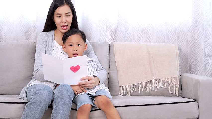 Lovely single mom getting present from kid happy mom enjoy reading handmade love card from small son cheerful embrace little child on mother day, valentine or birthday Love and care in family Royalty-Free Stock Footage #1109918963