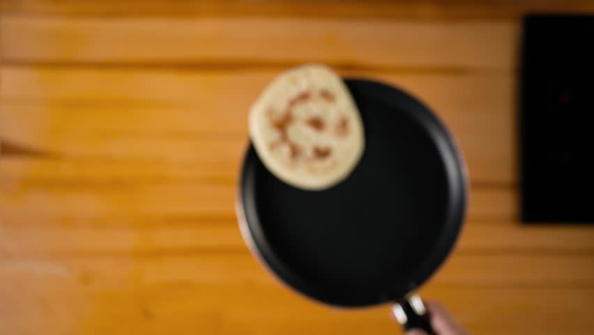 Cooking pancakes in a hot pan. Flipping pancake in up. Royalty-Free Stock Footage #1109919407