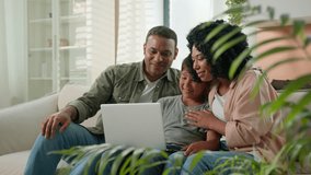 Happy African American family mom dad and teen son use laptop webcam distance video call multiracial parents little boy child wave hands smile greeting relatives remote communication on device at home