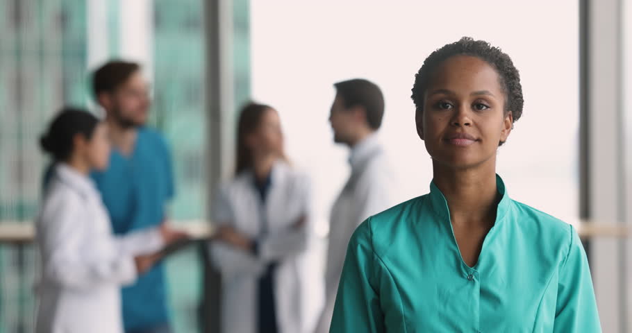 Caring smiling African nurse in green uniform showing heart symbol with joined fingers look at camera pose in clinic office, provide professional medical services to patients, health-care, insurance Royalty-Free Stock Footage #1109930325