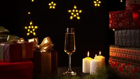 Festive atmosphere of Christmas or New Year, gifts and a glass of sparkling wine by candlelight - Powered by Shutterstock - Get 15% off with code: PIKWIZARD15